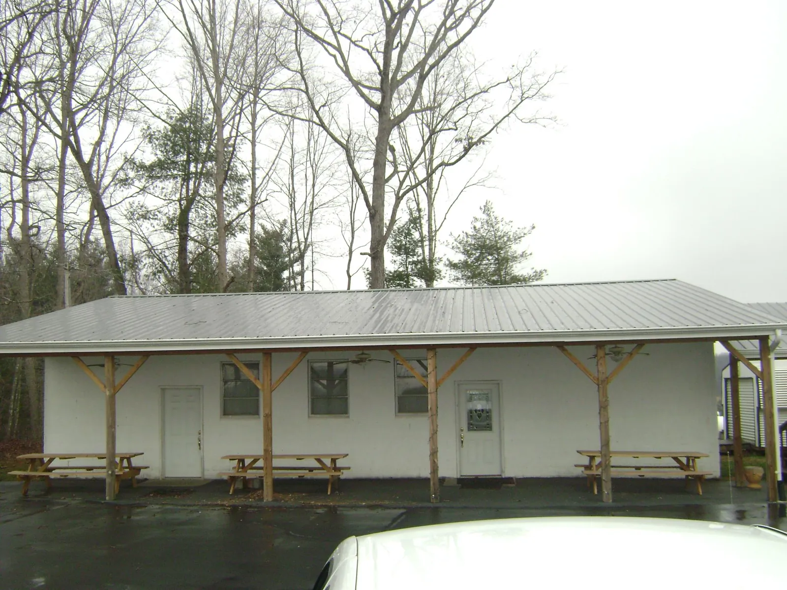 Gray metal roof over a block building with a timber post porch in Sugar City